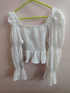 white bell bottom sleeves top.