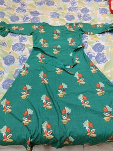 Its a Dark Green Colour Full Length Gown With Print Of Beautiful Flowers Overall In Xxl Size