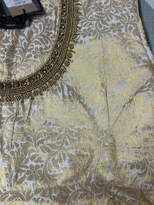 A Traditional Gold Top With Beautiful Neck To