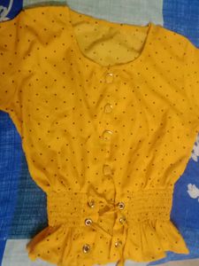 A Mustard Yellow Cinched Waist Top .