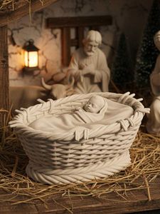 Cradle with baby Jesus for nativity scene