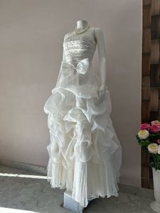 VOLUMINOUS RUFFLED ORGANZA WEDDING GOWN