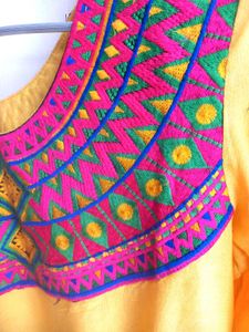 Yellow Kurti With Multicolor Embroidered Yoke