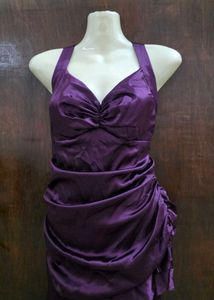 Purple ruffle dress with tailing on left side.