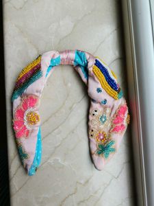Pink Hairband With Motifs.