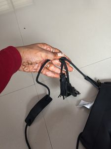 Chic Black Sling Bag with Tassel Detail