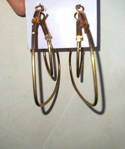Two Heart Shaped Hoops In Gold .