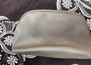 This is a taupe faux leather makeup bag