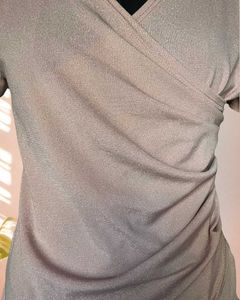 Pink shimmer top with ruching details on the waist