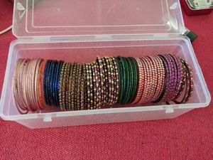 Around 85 bangles and wooden jewellery box