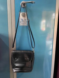 Black Sling Bag From Ajio. This Sling Is Sturdy and Useful For Keeping A Small Purse Along With Two Phones And Other Small Items. Bag Has 5 Compartments.