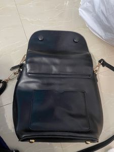 Black Sling Bag From Ajio. This Sling Is Sturdy and Useful For Keeping A Small Purse Along With Two Phones And Other Small Items. Bag Has 5 Compartments.