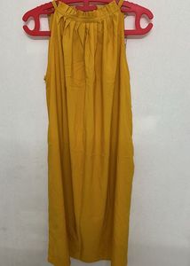 sleeveless mustard yellow top with a halter-style