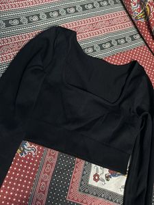 Black fitted long sleeve crop top with a thumbhole