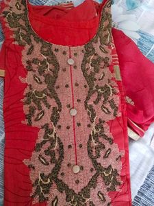 Red stitched women suit with pants and dupatta.