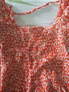 Orange Peplum Top With White Flowers