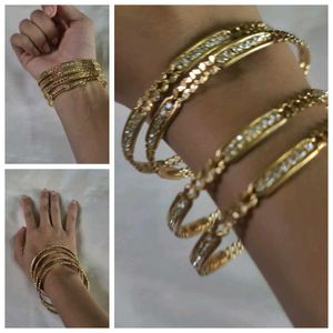 Elegant Gold-Toned Bangles with Clear Stones
