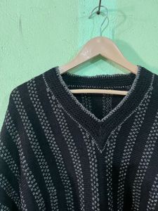 black V-neck sweater with wide, dolman-style sleev