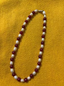 it’s a chain . it’s white and maroon mixed col