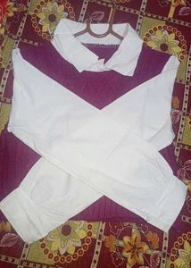 cable-knit sweater vest layered over a white colla