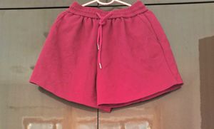 A pair of fuchsia shorts with  drawstring waist