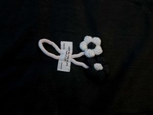 Black top with a knitted flower for women