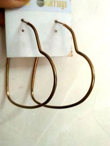 Two Heart Shaped Hoops In Gold .
