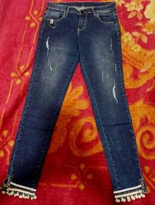 Distressed Jeans with Pom-Pom Hem