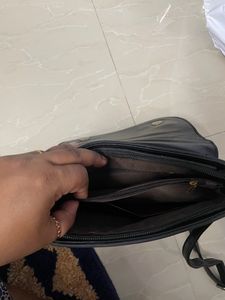 Black Sling Bag From Ajio. This Sling Is Sturdy and Useful For Keeping A Small Purse Along With Two Phones And Other Small Items. Bag Has 5 Compartments.