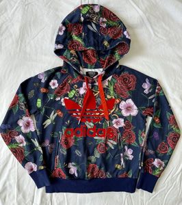 This is an Adidas x Rita Ora navy floral pullover
