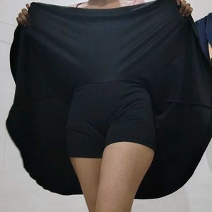 a black skirt with attached shorts inside