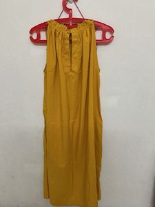sleeveless mustard yellow top with a halter-style