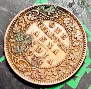 “1936” British India one-quarter Anna coin.