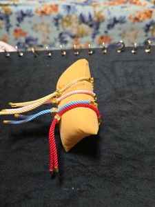 Set Of Four Guruji Thread Bracelets With Cushion