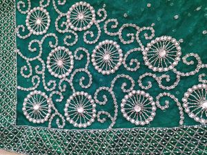 bottle green net saree with blouse and lehnga