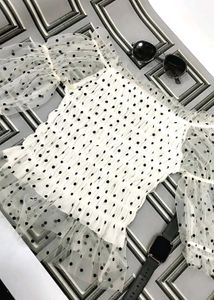 white, sheer top with black polka dots