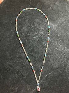 White metal chain with colourful pearls.