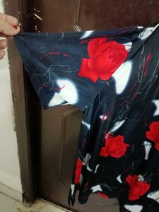 smart black top with red flowers on it