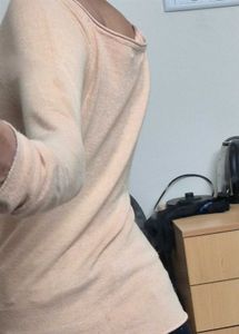 light beige or nude-colored long-sleeve top