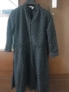 Black midi length dress with white dots.