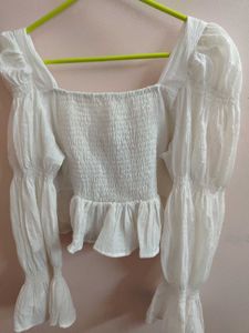 white bell bottom sleeves top.