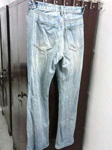 A ripped blue denim jeans