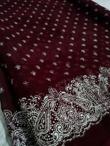 Burgundy saree having white design print.