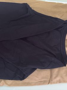 one black T-shirt with beige trousers