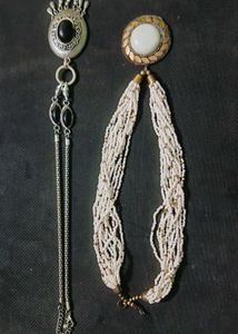 A Black Necklace along With White One