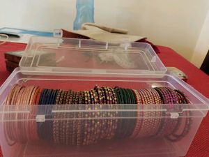 Around 85 bangles and wooden jewellery box