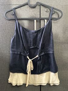 A Navy Blue &amp; Cream Coloured Tank Top.