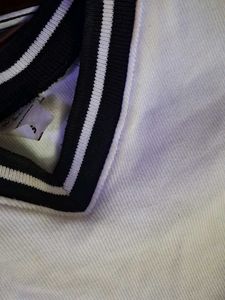 White crop top with black borders. Size S