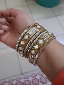 Stone Bangles Of White And Golden Color.