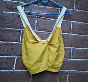 mustard yellow crop top .